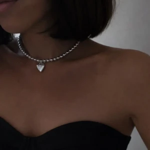 Model wearing SilverLove sterling silver heart choker necklace. A bold and Sterling silver heart choker necklace worn on neck, SilverLove collection